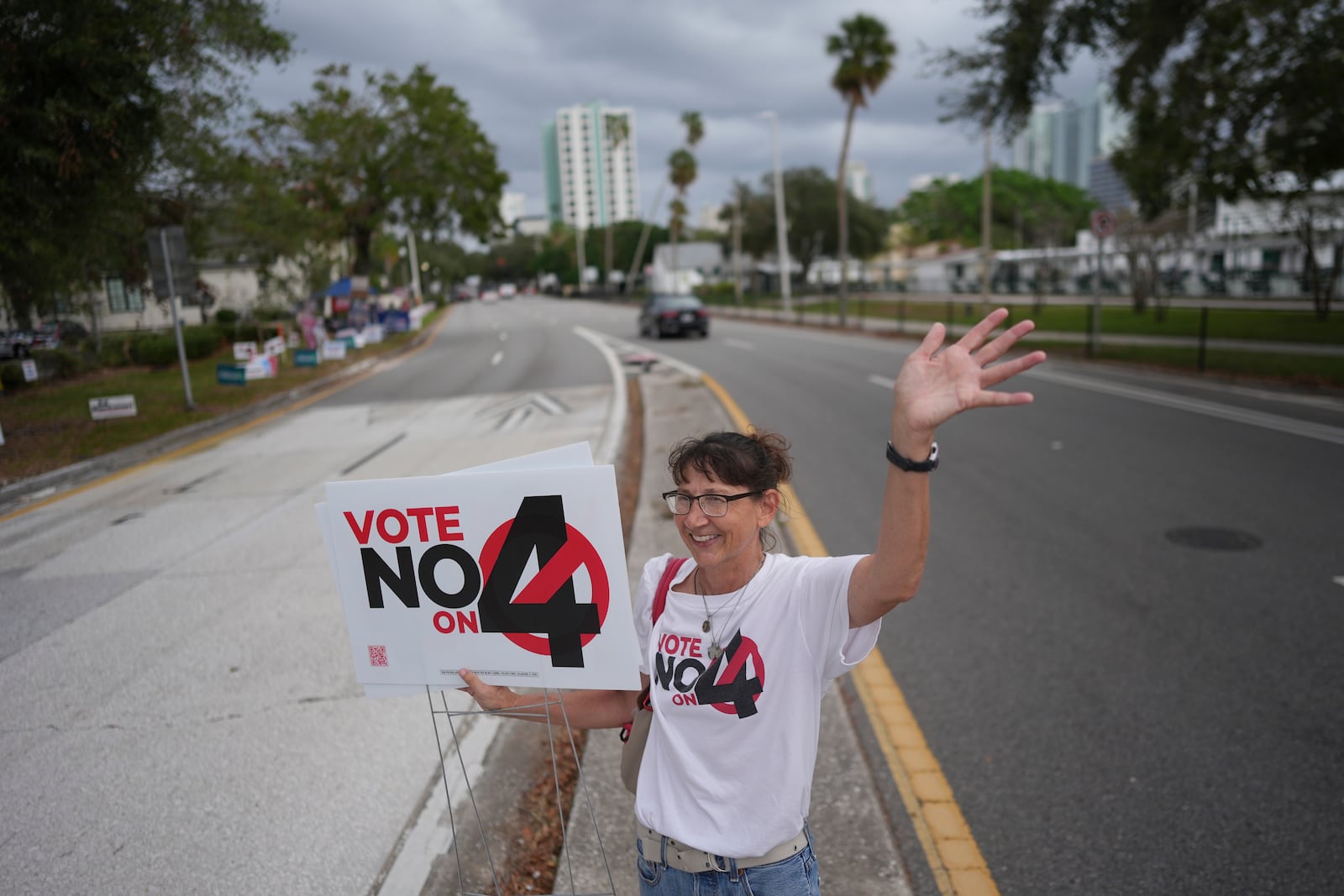 Pro-life Catholic Sonja Kahkonen waves to passing cars as she holds a "Vote No on 4" sign, urging voters to reject Amendment 4, which would enshrine abortion rights in the state, on Election Day, Tuesday, Nov. 5, 2024, outside a polling place at the Coliseum in St. Petersburg, Fla. (AP Photo/Rebecca Blackwell)