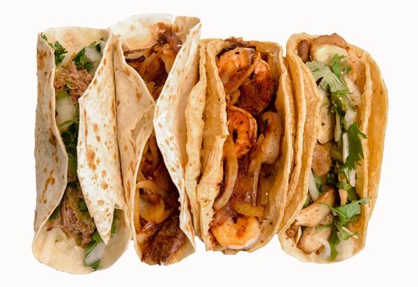 Tacos available from Bell Street Burritos include (from left): pork green taco on flour tortilla, chipotle pork taco on flour tortilla, shrimp chipotle taco on corn tortilla, and grilled chicken green taco on corn tortilla. CONTRIBUTED BY MATT HINTON / BELL STREET BURRITOS