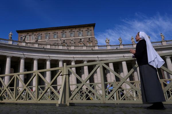 A nun prays towards the window at the Vatican at the time when Pope Francis would usually bestow his blessing, the Pontiff is currently recovering from a bilateral pneumonia at Rome's Agostino Gemelli Polyclinic, in Rome, Sunday, March 2, 2025. (AP Photo/Kirsty Wigglesworth)