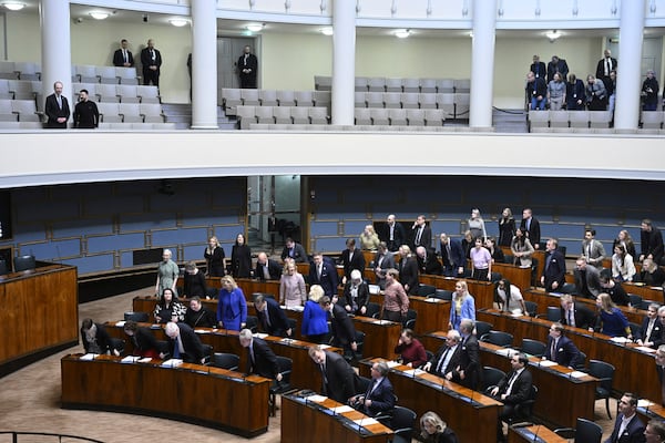 Ukrainian President Volodymyr Zelenskyy, second left in the gallery with Speaker of Parliament Jussi Halla-aho during his visit to the Parliament, in Helsinki, Finland, Wednesday, March 19, 2025. (Heikki Saukkomaa/Lehtikuva via AP)