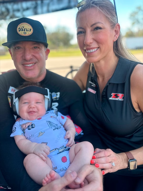 This photo provided by Ashley Wilson shows National Hot Rod Association drivers Tony Stewart, left, and Leah Pruett with their son, Dominic, during the start of the 2025 season, Tuesday, Feb. 4, 2025, in Bradenton, Fla. (Ashley Wilson via AP)