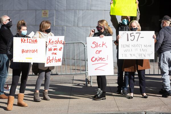 Protesters gathered outside City Hall on Monday after the city recorded 157 homicides in 2020.