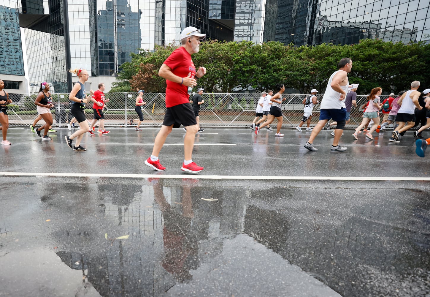 Runners take part in the 54th running of the Atlanta Journal-Constitution Peachtree Road Race in Atlanta on Tuesday, July 4th, 2023.   (Miguel Martinez / Miguel.Martinezjimenez@ajc.com)