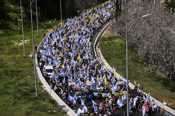 Israelis march on a highway toward Jerusalem to protest Prime Minister Benjamin Netanyahu's plans to dismiss the head of the Shin Bet internal security service, on Wednesday, March 19, 2025. (AP Photo/Ohad Zwigenberg)