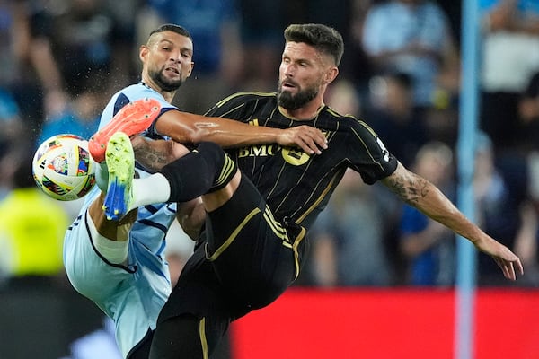 FILE - Sporting Kansas City defender Joaquin Fernandez, left, and Los Angeles FC attacker Olivier Giroud (9) battle for the ball during the first half of an MLS soccer match Saturday, Oct. 5, 2024, in Kansas City, Kan. (AP Photo/Charlie Riedel, File)