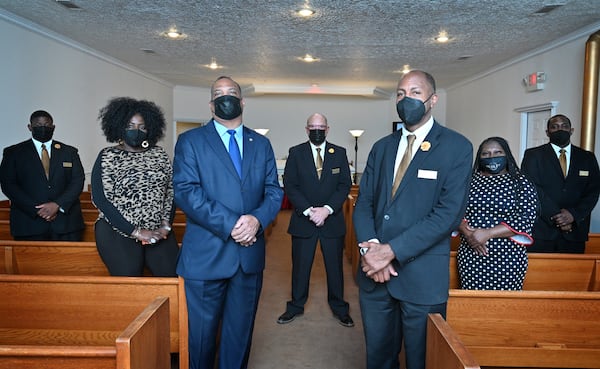 Dudley Funeral Home has been operating in Dublin for a century. In August and September of 2020, it was handling two or three services a day, said Carl Pearson (foreground right), director of client services. The funeral home usually does five or six funerals a week. Managing Director Alfred Pearson Jr. (foreground left) poses with the funeral home staff. (Hyosub Shin / Hyosub.Shin@ajc.com)