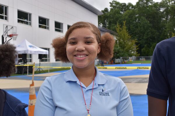 SAE School eighth grader Paris Howard took part in experiments to test the surface temperature of typical asphalt and asphalt covered in a reflective surface that's designed to reduce heat. Meris Lutz/meris.lutz@ajc.com