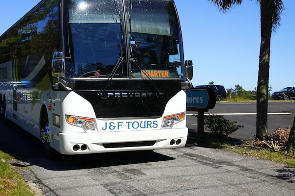 A charter bus carrying members and associates of the Transformative Justice Coalition arrives in the Satilla Shores neighborhood outside Brunswick, where Amhaud Arbery was killed last year. 