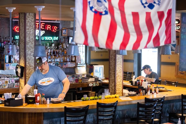 Manager Mitch Frohman (left) works at Steamhouse Lounge in Atlanta on Thursday, June 6, 2024. The restaurant just re-opened after being closed for five days following several water main breaks in the city. (Arvin Temkar / AJC)