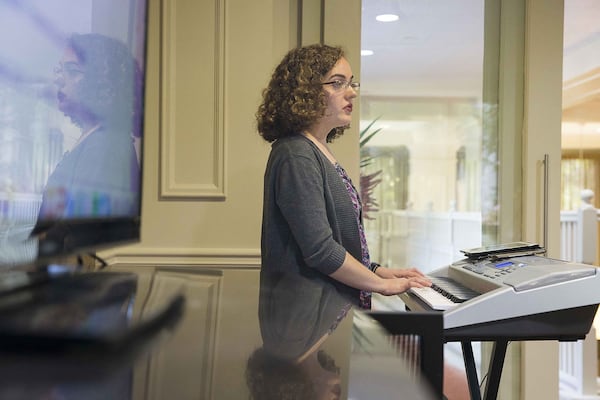 Music therapist Claire Morison, of the George Center, leads a group of individuals with Parkinson’s disease and their caregivers in a vocal warmup exercise during choir rehearsal. ALYSSA POINTER / ALYSSA.POINTER@AJC.COM