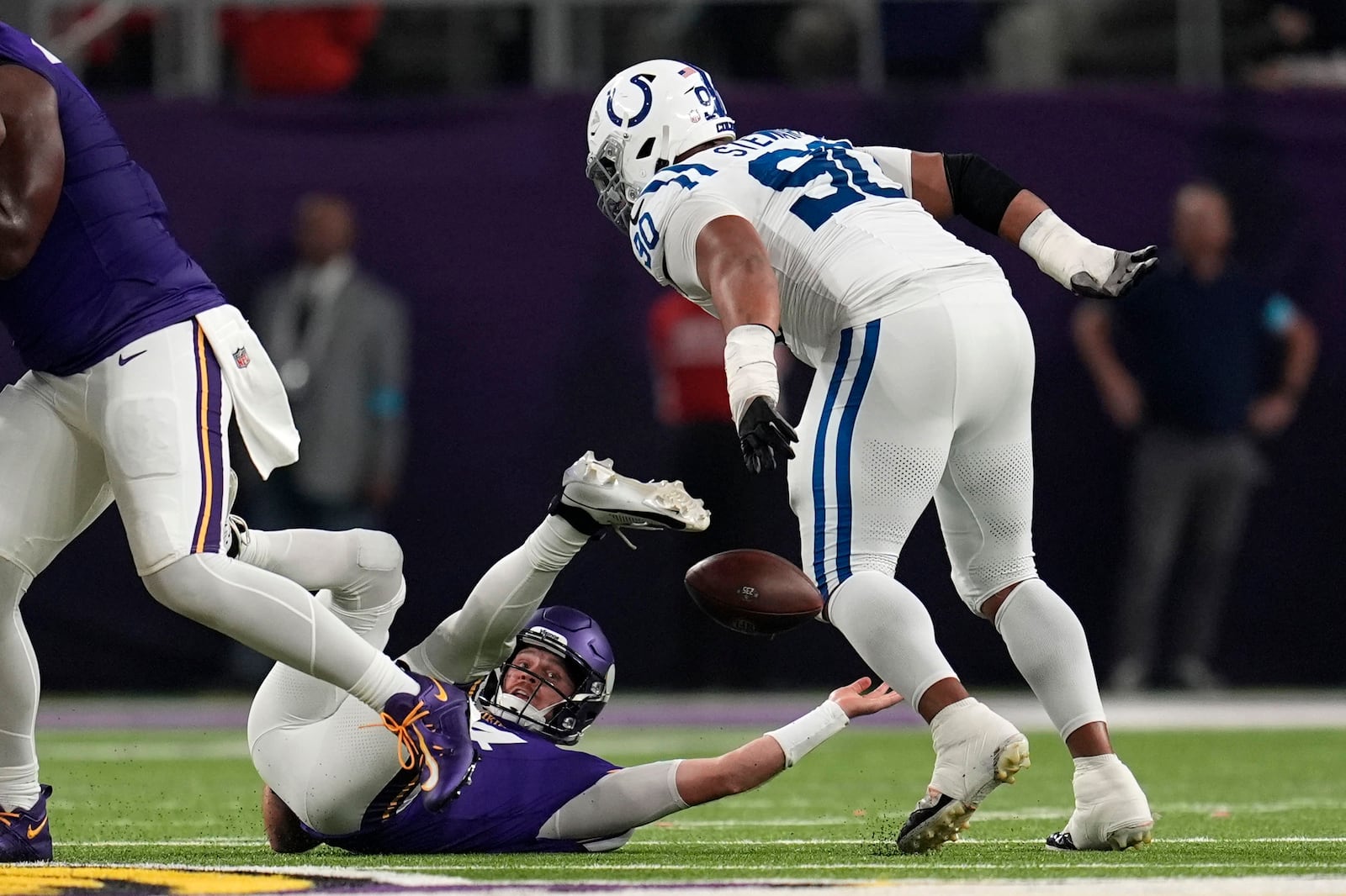 Minnesota Vikings quarterback Sam Darnold fumbles as he is tackled by Indianapolis Colts defensive tackle Grover Stewart, right, during the first half of an NFL football game, Sunday, Nov. 3, 2024, in Minneapolis. (AP Photo/Abbie Parr)