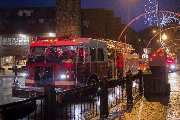 A Franklin Fire Department engine waits in a staging area in downtown Gatlinburg, Tenn., Wednesday, Nov. 30, 2016. Tornadoes that killed several people are adding to an onslaught of drought, flood and fire plaguing the South. The deadly overnight storms crashed into Alabama and Tennessee just as crews began to control wildfires around the resort town of Gatlinburg. (Andrew Nelles/The Tennessean via AP)