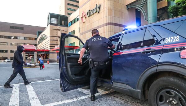 Atlanta police officers were on guard Thursday morning outside Grady Memorial Hospital, where a wounded officer was being treated.