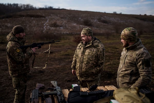 Capt. Oleksandr Puzikov, who lost an arm in combat, speaks with fellow soldiers in Ukraine's Kharkiv region on Feb. 3, 2025. (AP Photo/Evgeniy Maloletka)