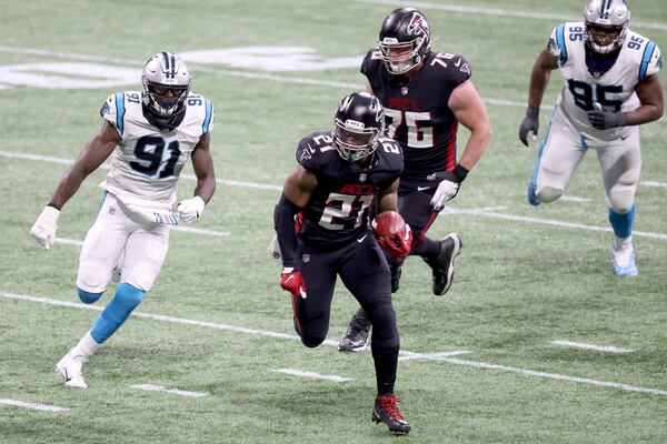 Falcons running back Todd Gurley (21) runs for yards against Carolina. (Jason Getz/For the AJC)