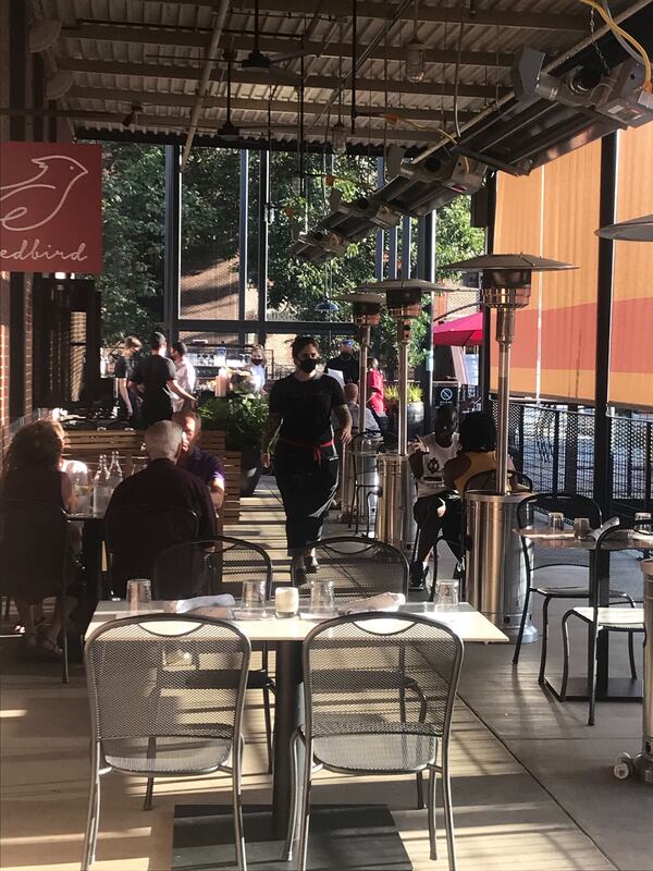 The patio at Redbird is socially distanced; heaters will warm the outdoor space as cooler temperatures set in. Ligaya Figueras / ligaya.figueras@ajc.com