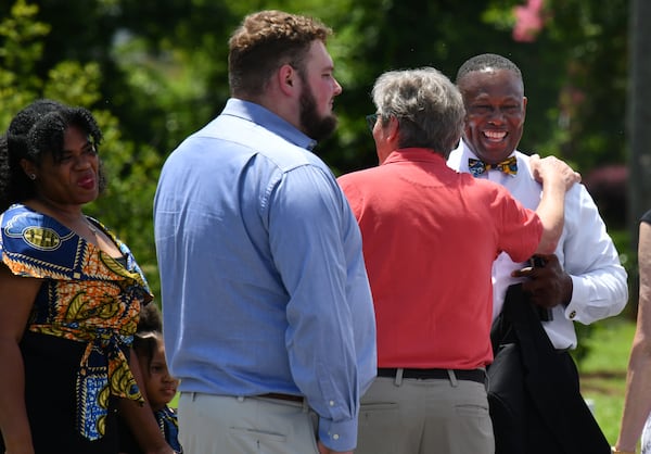 Tony Lowden (right), pastor of Maranatha Baptist Church, arrives with his family for 75th wedding anniversary celebration of former President Jimmy Carter and his wife, Rosalynn, at Plains High School on July 10, 2021. Hyosub Shin/AJC 2021