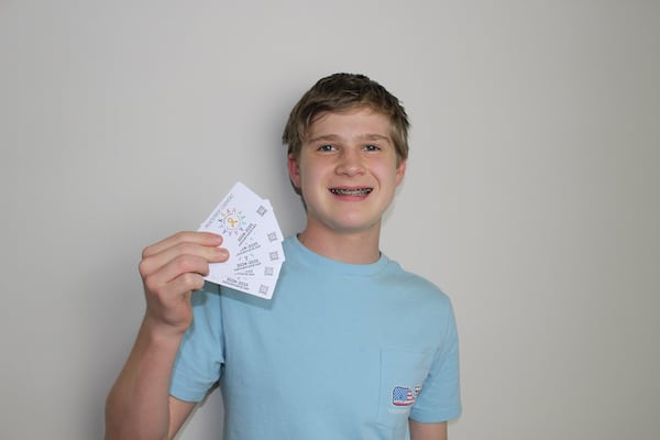 Lex Stolle, a high school sophomore from Johns Creek, is raising money to help cancer patients by selling Cancer Cards with months' worth of discounts. (Courtesy of Lex Stolle)