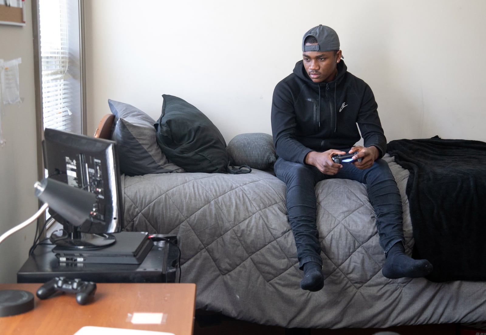 Kennesaw State University student Demetrius Taylor plays video games in his room Friday, November 13, 2020.   STEVE SCHAEFER / SPECIAL TO THE AJC 