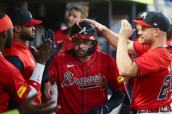 Atlanta Braves catcher Travis d'Arnaud celebrates his home run in the dugout during the fifth inning. (Jason Getz / AJC)
