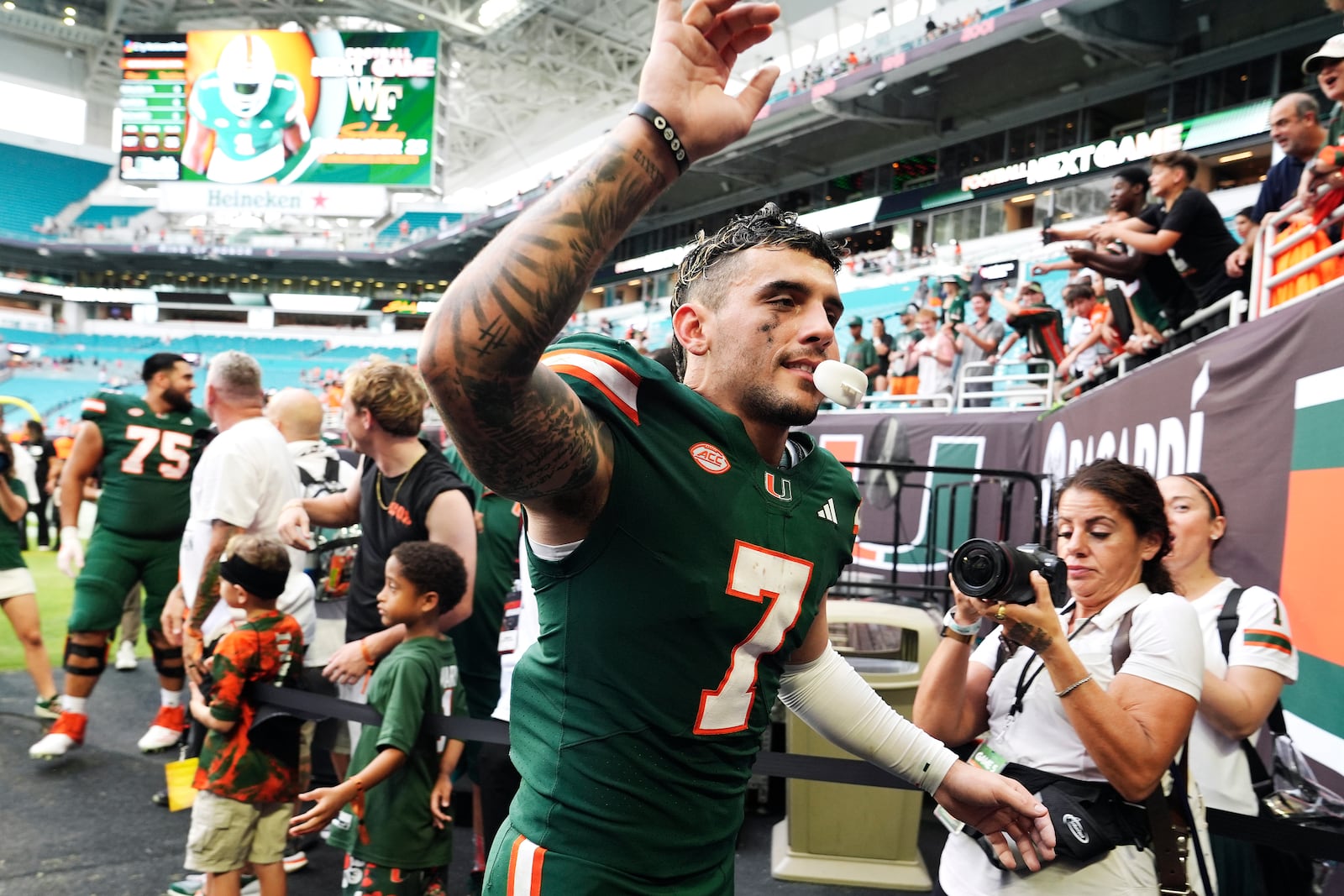 Miami wide receiver Xavier Restrepo (7) runs off the field an NCAA college football game against Duke, Saturday, Nov. 2, 2024, in Miami Gardens, Fla. (AP Photo/Lynne Sladky)