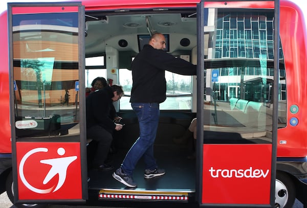 Vasili Karavidas, a representative from France for EasyMile, closes the doors of the company’s driverless vehicle for a test ride in metro Atlanta on Thursday, January 26, 2017. (HENRY TAYLOR / HENRY.TAYLOR@AJC.COM)