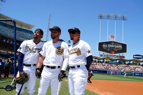 From left Ronald Acuña Jr., of the Atlanta Braves, catcher Wilson Contreras, of the Chicago Cubs, and his brother William Contreras, of the Atlanta Braves, stand together during batting practice before the MLB All-Star baseball game, Tuesday, July 19, 2022, in Los Angeles. (AP Photo/Jae C. Hong )