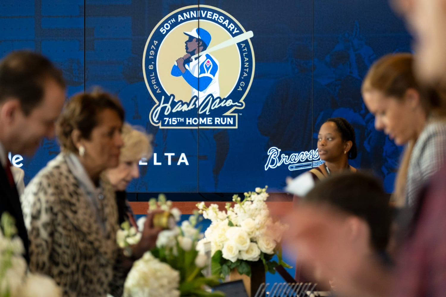 People arrive before the opening of the Atlanta History Center exhibit “More Than Brave: The Life of Henry Aaron” on Monday, April 8, 2024.   (Ben Gray / Ben@BenGray.com)