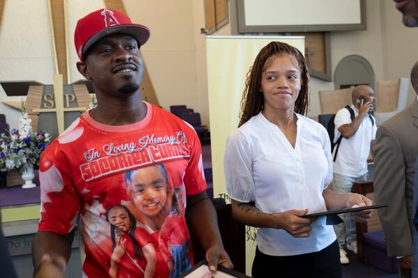 Secoriey Williamson and Charmaine Turner smile after hearing about extra pledges to the scholarship.