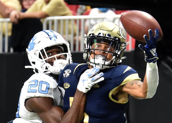 Georgia Tech's wide receiver Kalani Norris (5) is not able to catch under pressure from North Carolina's defensive back Tony Grimes (20). (Hyosub Shin / Hyosub.Shin@ajc.com)