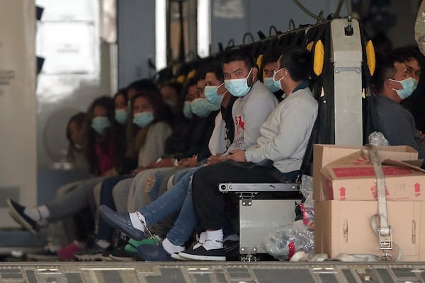 FILE - Migrants wearing face masks and shackles on their hands and feet sit on a military aircraft at Fort Bliss in El Paso, Tx., Jan. 30, 2025, awaiting their deportation to Guatemala. (AP Photo/Christian Chavez, File)