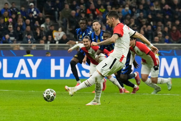 Feyenoord's Jakub Moder scores his side's opening goal during a Champions League round of 16 second leg soccer match between Inter Milan and Feyenoord, at the San Siro stadium in Milan, Italy, Tuesday, March 11, 2025. (AP Photo/Luca Bruno)