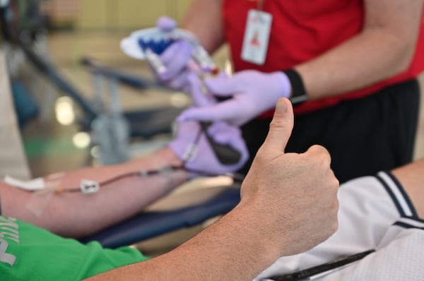 In this 2020 file photo, Brandon Hastings, gives a thumbs-up as he donates blood during Buford City Schools' annual Blood Drive at Buford Arena. (Hyosub Shin / Hyosub.Shin@ajc.com)