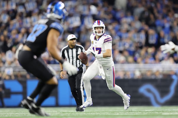 Buffalo Bills quarterback Josh Allen (17) rolls out to pass against the Detroit Lions during the first half of an NFL football game, Sunday, Dec. 15, 2024, in Detroit. (AP Photo/Rey Del Rio)