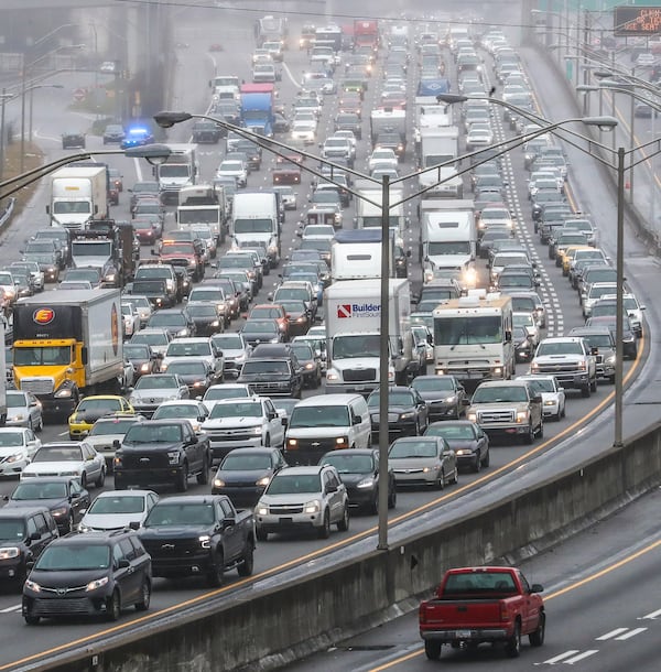 Atlanta Downtown Connector on February 15, 2021, when all southbound lanes were shut down for most of the afternoon after a tractor-trailer wrecked on a bridge and dislodged several yards of chain-link fencing. (John Spink / John.Spink@ajc.com)

