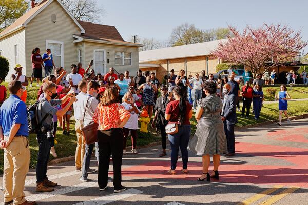 Evetty Satterfield, back to camera wearing a red shirt, the Knoxville School Board representative for District 1, speaks outside Austin-East High School after a shooting there April 12. (Shawn Poynter/The New York Times)