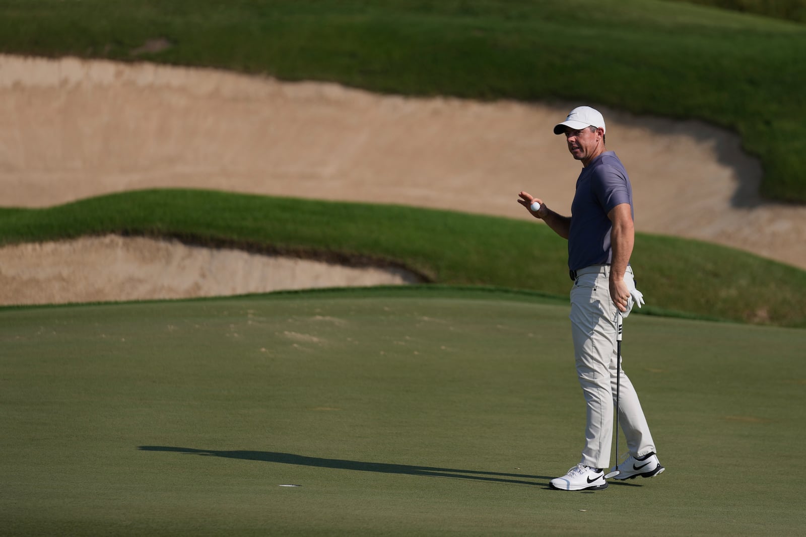 Rory McIlroy of Northern Ireland acknowledges the crowd after he playing his shot at the 12th green during the second round of Abu Dhabi Golf Championship in Abu Dhabi, United Arab Emirates, Friday, Nov. 8, 2024. (AP Photo/Altaf Qadri)