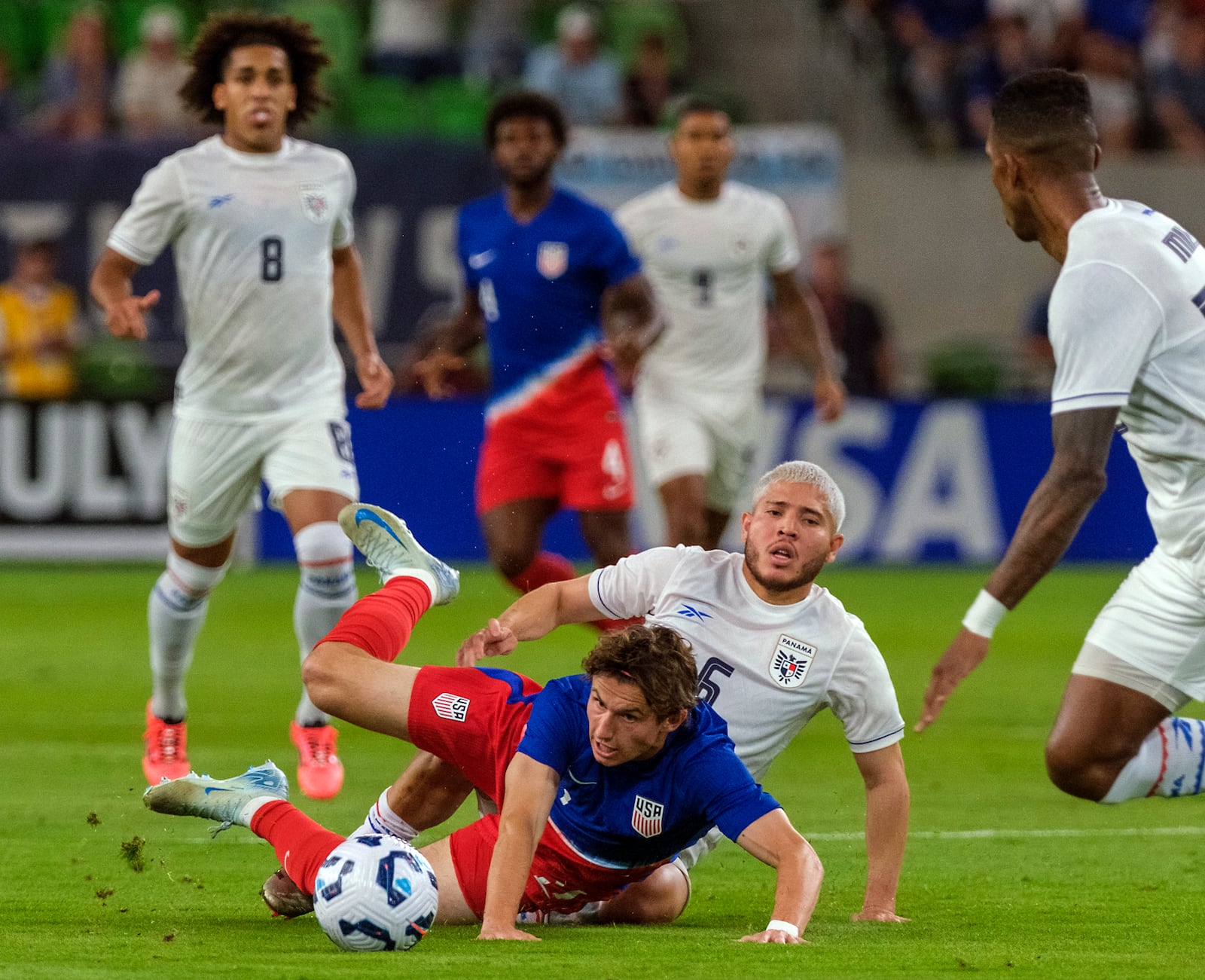 United States forward Brendon Aaronson, center front, is tackled by Panama midfielder Abidel Ayarza (5) during the first half of an international friendly soccer match, Saturday, Oct. 12, 2024, in Austin, Texas. (AP Photo/Rodolfo Gonzalez)