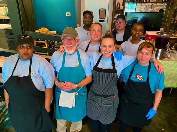 Brittney Espersen, front row and second from right, the general manager/chef at The Food Mill in Columbus, Georgia, poses for a photo in December 2023 with her kitchen team. (Photo Courtesy of Mike Haskey)