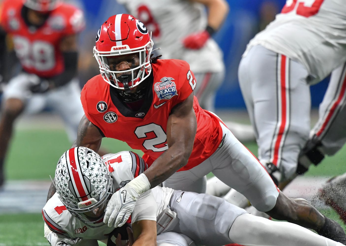 Georgia Bulldogs linebacker Smael Mondon Jr. (2) sacks Ohio State Buckeyes quarterback C.J. Stroud (7) for a ten-yard loss, forcing a punt during the first quarter. (Hyosub Shin / Hyosub.Shin@ajc.com)