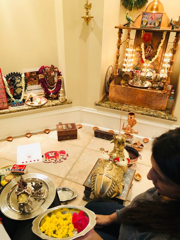 Bina Desai doing puja, a Hindu worship ritual that is done as part of Diwali celebrations, at her home.