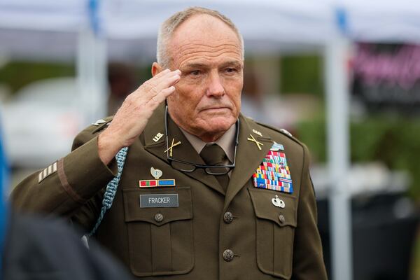 Coronel Al Fracker salutes the flag during the National Anthem during the 3rd Annual Veterans Day celebration at the ACE Hardware parking lot on Sunday, Nov. 10, 2024, in Lawrenceville.
(Miguel Martinez / AJC)