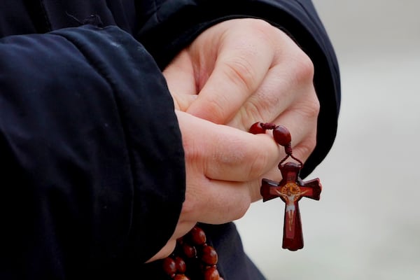 A man holds rosary beads as he prays for Pope Francis in front of the Agostino Gemelli Polyclinic, where the Pontiff has been hospitalized since Feb. 14, in Rome, Wednesday, Feb. 26, 2025. (AP Photo/Kirsty Wigglesworth)