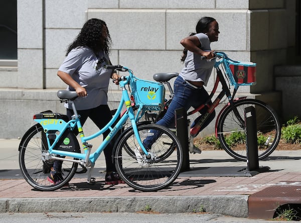 April 9, 2020 Atlanta: With the absence of scooters in the city Tarian Davis (right) and Nita Smith settle on a pair of the last remaining e-bikes at the Marta Midtown Transit Station on Tenth Street on Thursday, April 9, 2020, in Atlanta. For the past year, Atlanta residents and city leaders have complained about scooters lying in sidewalks and roadways leading to increased safety concerns for pedestrians and wheelchair users. Despite Atlantaâ€™s efforts to manage the problem, it seems all it took was widespread virus. Curtis Compton ccompton@ajc.com