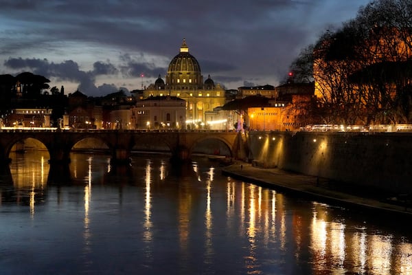 St Peter's Basilica at The Vatican is seen at dusk across the river Tiber in Rome, Italy Friday, Feb. 28, 2025. (AP Photo/Kirsty Wigglesworth)