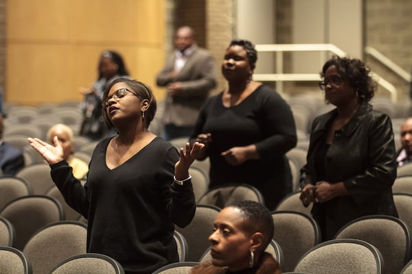 Members of the congregation of Transforming Faith Church pray during the Sunday service At Southwest DeKalb High School on Oct. 29, 2017. STEVE SCHAEFER / SPECIAL TO THE AJC