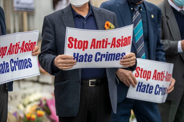 Members of the Atlanta Korean American Committee Against Asian Hate Crimes hold signs during a a vigil for the victims of the spa shootings outside of the Gold Spa in Atlanta on March 19, 2021. The committee consists of Korean-American community members, business leaders and religious leaders.  (Alyssa Pointer / Alyssa.Pointer@ajc.com)