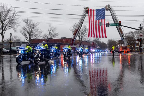 A funeral procession for fallen police officer Jeremy Labonte drives through downtown Roswell on Wednesday, February 12, 2025. The 24-year-old Roswell Police Department officer was shot to death on Friday evening. (Arvin Temkar / AJC)