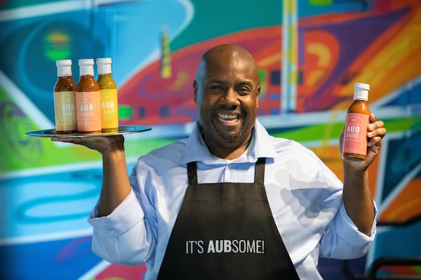 Aubrey Lenyard of AubSauce shows off the four flavors of his barbecue sauce line. CONTRIBUTED BY JARED SERFOZO