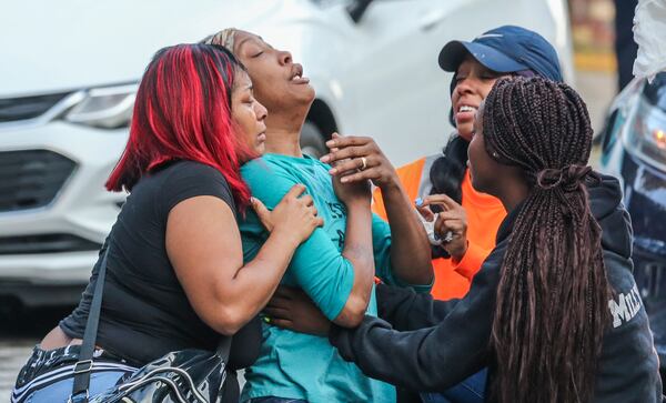 Sanmarian McClain (center-left) is comforted in her grief after losing her daughter to gunfire Thursday, Oct. 3, 2019. An 18-year old woman is dead after a stray bullet flew into her southwest Atlanta home and hit her as she slept. Gunfire erupted Thursday, in the street outside the home in the 2900 block of River Ridge Drive, according to Atlanta homicide commander Lt. Andrea Webster. Officers were sent to the residence about 6 a.m. after a woman reported her daughter had been shot and killed. When officers went inside the home, they found the victim with a gunshot wound to the chest, police said. Emergency medical officials confirmed she was dead.  Investigators learned there was an exchange between at least two shooters that may have lasted several minutes, Webster said. During that time, three stray bullets came into the house, one of which hit and killed the sleeping teen, she said.  âWe canât think of any reason she may have been the subject or the target,â Webster said.  The 18-year-old, identified by relatives as Jessica Daniels, had just graduated from South Atlanta High School in May, her mother told police.